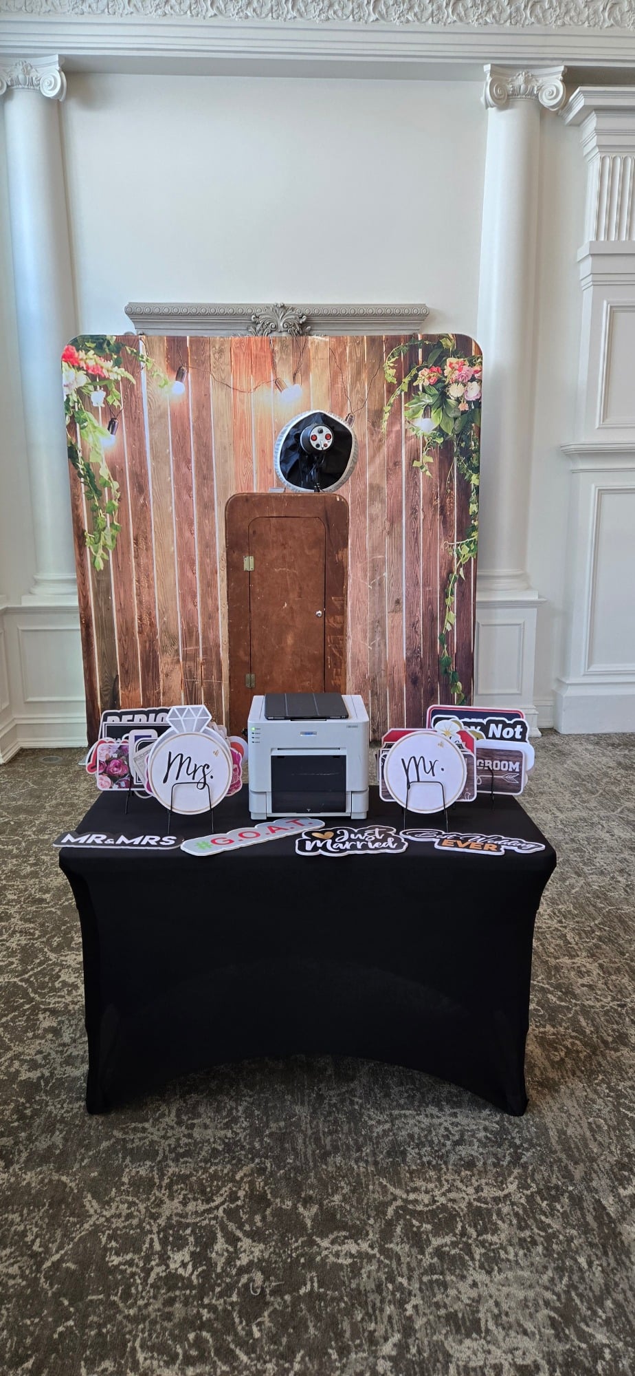 A 360 photo booth machine on a black table with Mr.