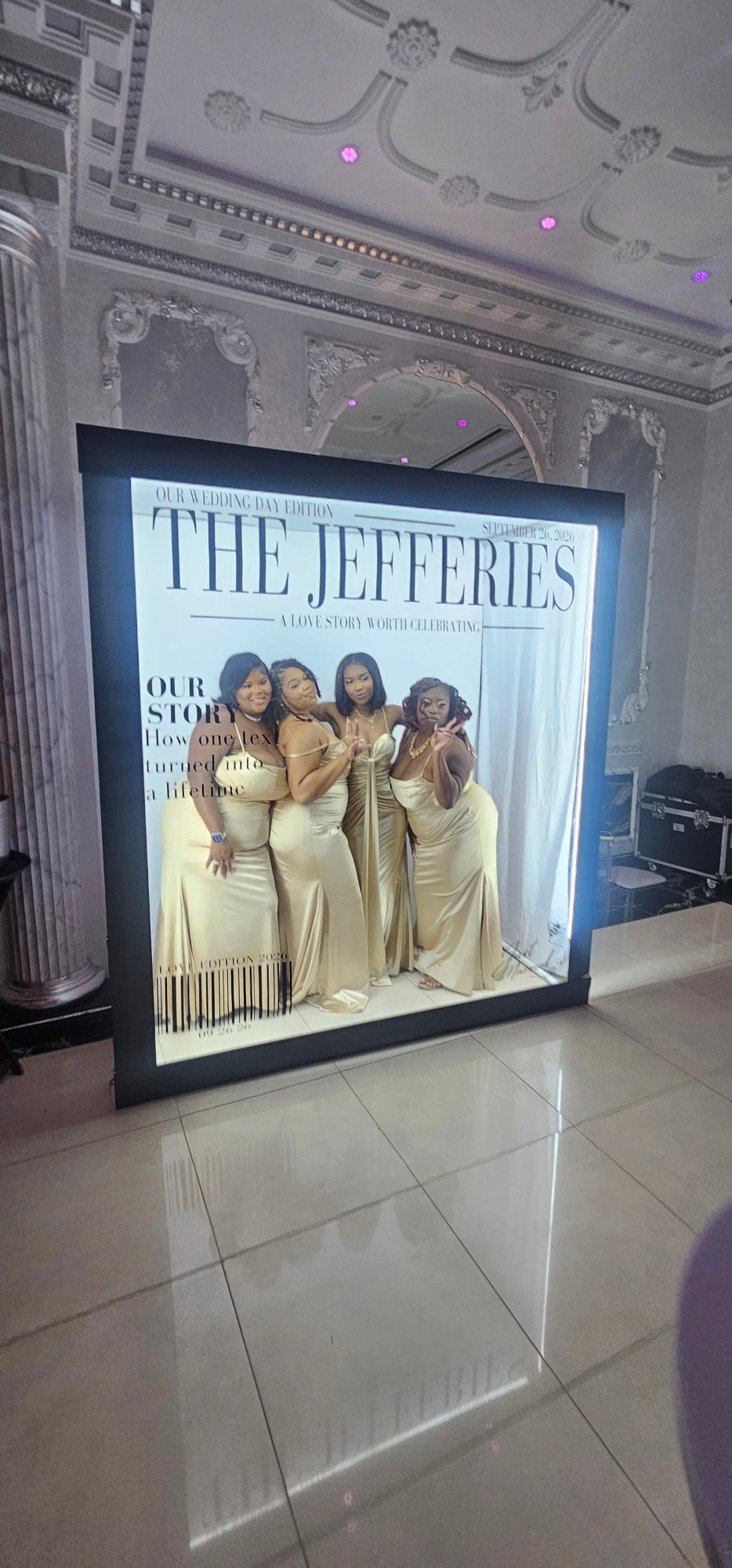 A large, black-framed lightbox displaying a custom magazine cover titled The Jefferies with four women in matching gold